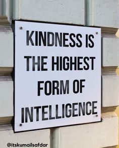 a sign on the side of a building that says, kindness is the highest form of intelligence