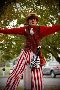 a man dressed in red, white and blue with his arms spread out to the side