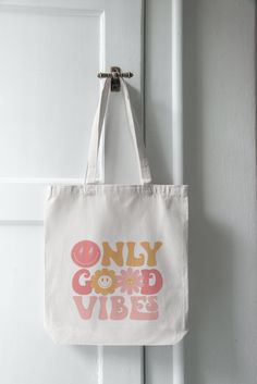 This Only good vibes tote bag is an excellent bag for just about anything and is very durable. Bring to the beach, on the boat, shopping. If you find yourself carrying so much you wish you had more hands!  This is the perfect bag for you. Measurements - Total Height with handle: 26 in. - Bag height: 16.5 in. - Bag width: 15 in. -Made of 100% cotton.  -Very useful for a verity of occasions.    Shopping, take to the beach, on the boat, use as an over night Bag.  -Please reach out with any questions or for bulk order details. If you would like to add your own picture, we can do that as well. Just specify when ordering or message and let me know what you want. Casual White Beach Bag With Letter Print, Trendy White Beach Bag With Letter Print, Casual Cotton Beach Bag With Letter Print, Trendy White Canvas Beach Bag, Trendy Cotton Tote Beach Bag, Trendy Cotton Beach Bag For Everyday Use, Trendy Cotton Beach Bag For Daily Use, Trendy Cotton Canvas Bag For Summer, Beach Canvas Bag With Letter Print