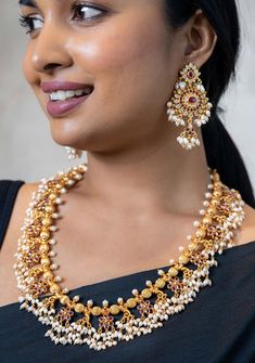 "Item: Necklace only, NO EARRINGS This 92.5 Silver, 24 kt gold-plated stylish Necklace is studded with semi-precious stones to make a stunning statement. It comes in a classic Guttapusalu design that is sought after for its dense clusters of beads that adds oodles of charm! Height-240 mm Width-160 mm This necklace comes with a dori. Should you need a 925 back chain attached, please purchase that separately here : 7\" 925 Silver Fish Hook Back Chain - Shobitam Note Product Care: To maintain the e Elegant Gold Necklaces For Designer Wear, Elegant Gold Necklace For Designer Wear, Designer Temple Necklace For Festivals, Elegant Gold Designer Wear Necklaces, Festive Designer Temple Necklace, Gold Temple Jewelry Necklaces For Designer Wear, Temple Jewelry Pearl Gemstone Necklace For Celebrations, Festive Temple Jewelry Pearl Necklace With Gemstone, Temple Jewelry Style Pearl Necklace For Celebration