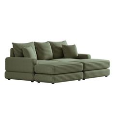 a green couch with pillows on the back and side ends, in front of a white background