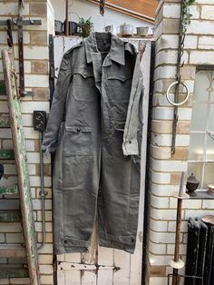 Vintage Bulgarian pilots flying suit overalls size XL. 100% Cotton. Collared, button through to crotch,  button down chest pockets, 2 lower pockets, button tabs at cuffs and legs - great utiliatarian workwear. Size:  Chest: 50 inches; Waist: 48 inches; Leg inseam: 28 inches; Total length: 61 inches. Weight: 2.6 kg (allow 5 kg volumetric weight once packed). Good vintage condition. For a larger selection of similar items, visit my website - www.AntheasAttic.co.uk (link on About page). Please cont Military Style Cotton Overalls, Utility Jumpsuits And Rompers With Pockets For Outdoor, Khaki Overalls With Pockets For Fall, Fall Khaki Overalls With Pockets, Military Style Long Sleeve Cotton Jumpsuit, Military Style Long Sleeve Cotton Jumpsuits And Rompers, Military Style Jumpsuits And Rompers With Pockets, Military Style Khaki Jumpsuit, Utility Style Khaki Jumpsuits And Rompers With Pockets