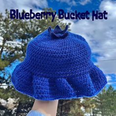 a blueberry bucket hat is shown in front of trees