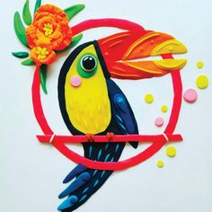 a colorful bird sitting on top of a red circle with an orange flower in it's beak