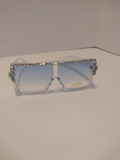 Large Sunglasses with Rhinestones with a blueish tint, three stars on frame. Trendy Bling Sunglasses With Glass Material, Trendy Bling Sunglasses With Glass, Trendy Bling Sunglasses With Glass Lenses, Silver Sunglasses With Rhinestones, Silver Rhinestone Sunglasses With Glass, Silver Rhinestone Sunglasses With Glass Lenses, Adjustable Clear Sunglasses For Parties, Large Sunglasses, Three Star