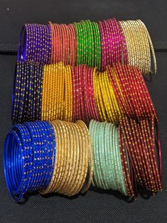 A set includes 12 bangles. Base material is made of aluminium and then color coated with gold glitter. Available in Inner Diameter: 2.25, 2.37, 2.5 inches. 2.25 inches is commonly referred as 2x4 Indian size. 2.37 inches is commonly referred as 2x6 Indian size. 2.5 inches is commonly referred as 2x8 Indian size. Please allow some variation in color. Match your outfits with these colorful trendy bangles. Please note: Excess glitter will fall off after couple of use. Do not expose to water. Bangles Aesthetic, Indian Bridal Bangles, Wedding Return Gifts, Diy Hair Accessories Tutorial, Accessories Tutorial, Bangle Ceremony, Hair Accessories Tutorial, Stunning Rings, Jewellery Bangles