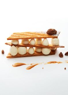 some kind of food that is on top of a white surface with peanut butter and other things