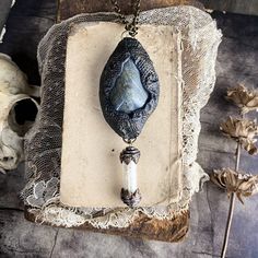 This necklace is handcrafted from a special blend of clay that I have etched and shaped. It features a powerful piece of labradorite and a vial of naturally shed snake skin.Labradorite is a stone of transformation and mysticism, highly revered for its spiritual properties and benefits. Labradorite is known as the stone of transformation, aiding in personal growth and change. It’s believed to help you navigate through transitions with strength and perseverance.It creates a shielding force throughout the aura, protecting against negativity. This makes it an excellent stone for healers and those seeking spiritual growth.Labradorite is said to enhance intuitive and psychic abilities, including clairvoyance, telepathy and prophecy. It’s also associated with the third eye chakra, which governs i Sacred Masculine, Conjure Oil, Fire Element, Medicine Bag, Sacred Feminine, Goddess Energy, Earth Elements, Doll Jewelry, Third Eye Chakra