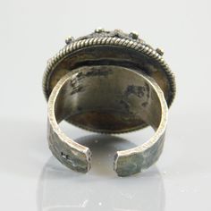 Big sterling cannetille ring has a cone shape with a wide hammered sterling band. This tall, big ring has a wonderful ethnic, tribal look. The cone shape has a rope style border around the base. The band is very sturdy but can be adjustable to some degree. It is currently a size 7 and the tip of the cone is 1/2 inch tall and the setting is 13/16 inches in diameter. This unique ring is signed but it is very tiny. I see a hallmark that looks like a triangular paw with toe nails and separate mark t Artisan Adjustable Rings For Festivals, Adjustable Bohemian Ceremonial Rings, Bohemian Engraved Filigree Ring, Unique Metal Rings For Festivals, Unique Adjustable Rings For Ceremonial Occasions, Unique Adjustable Ceremonial Rings, Vintage Adjustable Rings With Unique Design, Unique Handmade Filigree Ring, Unique Festival Toe Rings