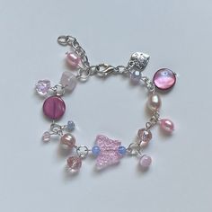 "A Handmade bracelet ✿ Made with freshwater pearls, rose quartz, mother of Pearl, glass crystal beads, metal accents, and glass beads ✿ Pearlescent peach, pink, sky blue, fuschia, lavender, and silver ✿ The bracelet has an additional 1-1.5\" of extension chain. Some beads may be added or removed depending on the length selected" Pink Charm Bracelet With Colorful Beads, Pink Pearl Beaded Bracelets With Colorful Beads, Pink Charm Bracelet With Colorful Beads For Jewelry Making, Pink Beaded Bracelet With Pearl Charm As A Gift, Pink Beaded Bracelet With Pearl Charm For Gift, Pink Charm Bracelet For Jewelry Making With Spacer Beads, Silver Beaded Rose Quartz Bracelets, Pink Pearl Charm Bracelet, Pink Beaded Crystal Bracelet For Jewelry Making