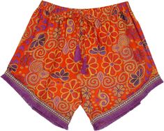 A bright orange with complementary purple fringes and drawstring tassels - these pair of shorts have pockets on both sides.  The shorts have an elastic waistband along with a drawstring with tassels at its ends. #tlb #Fringe #Pocket #vacationclothing #Floral #Printed #FunShorts #TasselShorts #SummerShorts #OrangeandPurpleShorts Orange Vacation Shorts With Elastic Waistband, Orange Beachwear Shorts With Elastic Waistband, Red Drawstring Shorts For Vacation, Orange Beach Shorts With Elastic Waistband, Multicolor Drawstring Shorts, Casual Festival Bottoms With Tassels, Hippie Shorts, Fun Shorts, Tassel Shorts