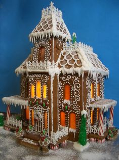 a gingerbread house is decorated with icing and candy canes