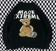 a black sweater with a teddy bear on it