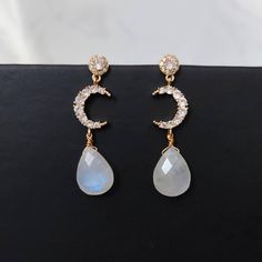 Bedazzle everyone with this flashy Rainbow Moonstones earrings! Great as a gift for weddings, birthdays, anniversary or even for yourself. Handmade with Natural Rainbow Moonstones and 14K Gold Plated Cubic Zirconia Crescent Moon connector with 925 Silver Vermeil studs. Nickel free, suitable for sensitive skin. Get a matching necklace at below link: http://www.icingonrocks.etsy.com/listing/1314375345 Measurements --------------------- Main stone dimensions (height x width):  1.6 x 1.2 cm / 0.63 x Elegant Moon-shaped Party Jewelry, Elegant Moon Charm Drop Earrings, Gemstone Dangle Chandelier Earrings For Wedding, Wedding Chandelier Dangle Earrings With Gemstones, Wedding Chandelier Earrings With Gemstones, Moonstone Crystal Dangle Earrings, Elegant Gold Crystal Earrings With Moonstone, Elegant Moon Shaped Cubic Zirconia Earrings, Elegant Moon-shaped Earrings For Parties