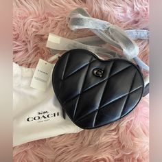 Spread Love Wherever You Go With This Fabulous Quilted Leather Heart Crossbody By Coach. Description: Style Id: Ce725 Color: Pewter/Black Mini Sized Bag; 7-1/2"W X 6-1/2"H X 2-1/4"D (Width Is Measured Across The Bottom Of Handbag) Silhouette Is Based Off 5'9" Model 23"L Detachable Strap Zip Closure Silver-Tone Exterior Hardware & Logo 1 Interior Credit Card Slot Bag Converts From Crossbody To Clutch By Removing Strap Polished Pebble Leather; Trim Signature Coated Canvas (Cotton/Polyester) Profes Chic Leather Bag For Valentine's Day, Chic Heart-shaped Leather Bag, Elegant Leather Bags For Valentine's Day, Chic Black Heart-shaped Shoulder Bag, Elegant Leather Shoulder Bag For Valentine's Day, Chic Black Bag For Valentine's Day, Chic Black Heart-shaped Bag, Chic Coach Heart-shaped Bag, Black Leather Heart-shaped Bag