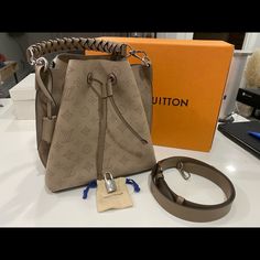 Retails For 4650usd + Tax In Excellent Practically New Condition. No Scratches On Hardware One Little Scuff On The Leather On The Silver Hardware (Shown In Photo). Barely Noticeable Comes With Strap Dust Bag And Box Made In France Ah4149 Beautiful Galet Gray Color 9.8l X 9.8h X 7.9w Please Ask All Questions And Any Additional Photos Prior To Purchase. Have It Posted For Less On Lv Fb Group Designer Monogram Canvas Bucket Satchel Bag, Designer Monogram Canvas Bucket Bag With Top Handle, Designer Bucket Bag With Removable Pouch, Brown Monogram Canvas Bag With Palladium Hardware, Designer Travel Bucket Bag, Designer Bucket Bag For Travel, Brown Monogram Canvas Bucket Bag, Designer Brown Bucket Bag, Designer Monogram Canvas Bucket Bag For Daily Use