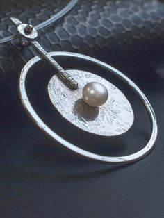 This is a large Pendant crafted on fine Silver beautifully balanced with a genuine cultured Pearl in the center. Ideal bridal necklace. Available on Diapiro' eshop Price 126 euros and free experss shipping. #silver_necklace #silver_jewelry _bridal_necklace #wedding_jewelry #women's_style #women's_fashion #silver_pendant #statement_necklace #geometric_pendant #Pearl #woman's_accesories Modern Round Pearl Drop Jewelry, Metal Pearl Drop Necklace, Modern Pearl Pendant Necklace, Modern Pearl Drop Pendant Necklace, Metal Pearl Charm Necklace, White Round Pearl Necklace, Modern Silver Jewelry With Pearl Drop, Minimalist Silver Metal Pearl Necklace, Silver Minimalist Pearl Necklace