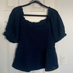 Denim Blue Puff Sleeve Top Old Navy Square Neck With Ruffles Peplum Style 100% Lyocell Ruched Bodice Pit To Pit 17” Shoulder To Hem 23.5” Size Large Casual Cotton Puff Sleeve Top, Casual Puff Sleeve Top With Smocked Bodice, Casual Blue Cotton Puff Sleeve Top, Casual Smocked Top With Puff Sleeves For Day Out, Casual Puff Sleeve Top With Smocked Back, Casual Denim Puff Sleeve Tops, Casual Denim Tops With Puff Sleeves, Casual Cotton Puff Sleeve Top With Smocked Bodice, Trendy Denim Blue Puff Sleeve Tops