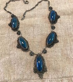 "An Antique silver finely hand wrought Swiss Lapis(dyed Jasper-the period stone used in these early Italian pieces), Necklace-Probably a souvenir of the Grand Tour-late 1800s to early 1900s. Fratelli Peruzzi dates back to the 1880s-Florence I believe on the Ponte Vecchio Bridge location.  Condition I see no problems, spring ring clasp works, oval cabochon stones are securely bezel set, the detailed fineness to these early Peruzzi pieces is difficult to believe-the masterful soldering to construc Ornate Oval Cabochon Necklaces, Formal Cabochon Pendant Necklace, Traditional Oval Cabochon Necklace, Traditional Oval Hallmarked Necklaces, Traditional Oval Cabochon Necklaces, Traditional Oval Hallmarked Necklace, Unique Oval Jewelry For Ceremonial Occasions, Formal Silver Pendant Custom Necklace, Antique Formal Jewelry With Cabochon