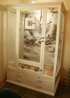 a white cabinet sitting in the corner of a room