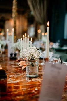 the table is set with candles and flowers