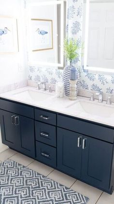 a blue and white bathroom with double sinks