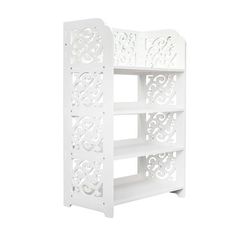 a white book shelf with intricate carvings on the top and bottom shelves, against a white background