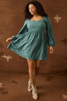 This dress features a relaxed babydoll silhouette, offering a playful and feminine look that's perfect for any occasion. The long sleeves provide a touch of elegance and warmth, making it ideal for cooler days. The dress is versatile enough to be dressed up with heels or kept casual with boots or sneakers. Babydoll Dress Long Sleeve, Babydoll Dress Long, Dress With Cowgirl Boots, Plus Size Mini Dresses, Puff Sleeve Dresses, Feminine Look, Babydoll Dress, Dress Romper, Hunter Green