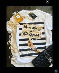 This crew neck true fit T-shirt has a fun designer inspired graphic in the front easy to dress up with fun jewelry and leather or throw on with jean shorts 100% cotton Washable Chanel Tee, Chanel T Shirt, Dope Tees, Chanel Inspired, Ankle Strap Sandals Heels, Fun Jewelry, Paris Woman, Country Shirts, Need Money