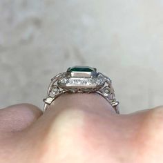 A rare emerald and diamond halo ring featuring a 1.06 carat natural Colombian emerald with no clarity enhancement. Surrounding the center diamond is a halo of old European cut diamonds. This ring has a low profile.
The center emerald is certified by AGL, which states that the emerald is Colombian and is not treated. No oil emeralds are very rare and are considered investment quality.
The measurements of the emerald are 7.55mm x 6.35mm x 3.66mm.
This ring can be resized to any finger size at no e Green Brilliant Cut Platinum Halo Ring, May Birthstone Asscher-cut Diamond Ring, Green Platinum Halo Ring With Center Stone, Heirloom Emerald Ring With Halo Design, Green Emerald Platinum Ring With Halo Setting, Green Emerald Ring With Halo Setting In Platinum, Emerald Ring With Halo Setting In Platinum, Green Emerald Cut Diamond Ring With Rose Cut Diamonds, Platinum Emerald Ring With Halo Setting For Anniversary