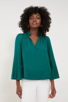 Effortlessly elevated, the Rosemary Phillipa Blouse has a slight sheen to it that accentuates its luxe green hue. This top drapes off the body in the most flattering way and features a stand collar with a gathered neckline, bracelet length sleeves, and a lightweight fabric that feels soft to the touch. Opt for light de Gathered Neckline, Cocktail Attire, Flutter Sleeve Top, A Stand, Wide Sleeves, Light Denim, Trendy Tops, Pullover Sweatshirts, Fall Trends