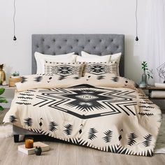 a bed with black and white designs on it