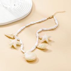 Material: Alloy Color: White Fashion Element: Starfish Style: INS Style White Star-shaped Ocean-inspired Jewelry, Ocean-inspired White Star Jewelry, Ocean-inspired White Star-shaped Jewelry, White Star Necklace For Beach, Starfish Shell Necklace For Vacation, White Shell Necklace With Starfish Charm, White Necklace With Starfish Charm For Vacation, White Starfish Shell Necklace With Starfish Charm, White Starfish Necklace For Summer