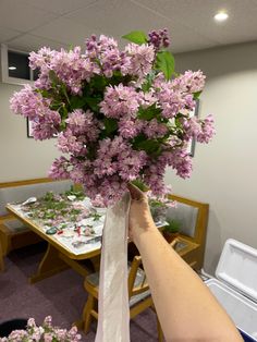 a person holding a bouquet of flowers in their hand