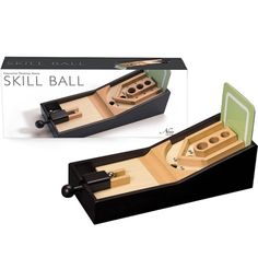 a box with two wooden paddles in it next to a cardboard box that says skill ball