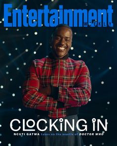 the cover of entertainment magazine showing a smiling man in plaid shirt and tie with his arms crossed