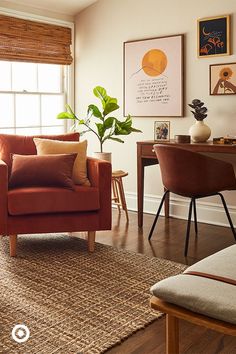 a living room filled with lots of furniture and paintings on the wall above it's windows