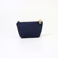 Introducing the Geometric Poofy Coin Pouch: a delightful blend of charm and versatility. This unique pouch combines a playful pink geometric pattern on one side with durable navy dry oilskin on the other, offering a stylish contrast that stands out. Measuring approximately 3.5" x 5" with a poofy, 1" gusseted design, this pouch not only holds your coins and small essentials but also stands on its own for easy access. The brass-colored metal zipper ensures secure closure, while adding a touch of vintage elegance to its modern design. Whether slipped into a purse or carried solo, the Geometric Poofy Coin Pouch is perfect for adding a pop of color and personality to your everyday carry. It's an ideal accessory for those who appreciate practicality without compromising on style. Modern Pouch With Coin Pocket For Everyday Use, Modern Portable Pouch For Everyday Use, Modern Coin Purse With Removable Pouch, Minimalist Rectangular Everyday Coin Purse, Minimalist Everyday Rectangular Coin Purse, Modern Compact Coin Purse For Personal Use, Compact Modern Coin Purse, Modern Compact Everyday Pouch, Everyday Zipper Pouch Coin Purse