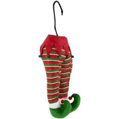 a green and red striped christmas stocking hanging from a hook