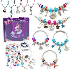 several bracelets and charms are displayed in front of a card board with the words believe in