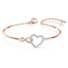 This heart bracelet combines the precision and quality of sparkling crystals with a chic rhodium plated chain, making this endearing look a cute accessory. A single white crystal adorns a dainty infinity sign interlaced with a dazzling white crystal pave heart, adding a brilliant and romantic touch to the simple, refined design. Teen Slang, قلادات متدلية, Heart Bangle Bracelet, Inexpensive Jewelry, Womens Bangles, Swarovski Bracelet, The Bangles, Infinity Heart, Classy Jewelry