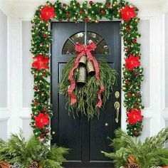 christmas wreaths and bells are hanging on the front door