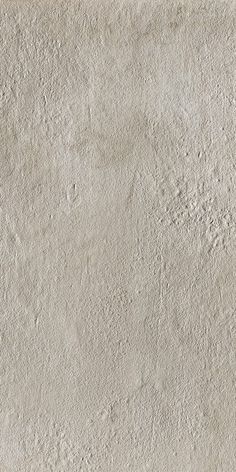 a white stucco wall textured with cement