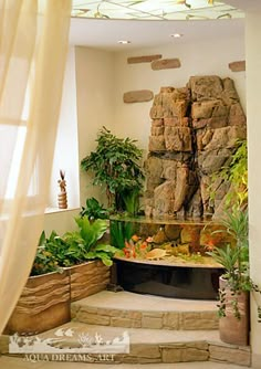 a living room filled with lots of plants and rocks