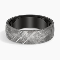 a wedding band that is made out of black and white marble