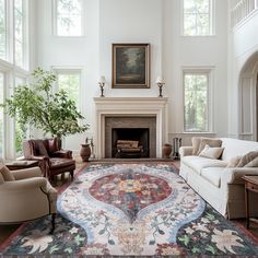 a living room filled with furniture and a large rug on top of a hard wood floor