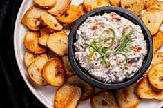 a white plate topped with crackers and dip