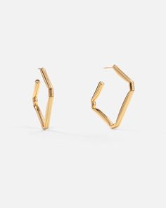 Slip these sleek folded square hoop earrings on, and add flair to your work, casual, or night wardrobe. Created with a deconstructed geometric shape and a subversive-basic design concept, these bright polished hoops exude modern minimalism.

Size: 43x42mm
Material: 18k Gold Plated On Brass 6 Fingers, Miao Silver, Square Hoop Earrings, Open Hoop Earrings, Basic Design, Modern Minimalism, Earrings In Gold, Recycled Sterling Silver, Design Concept