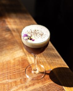 a drink sitting on top of a wooden table