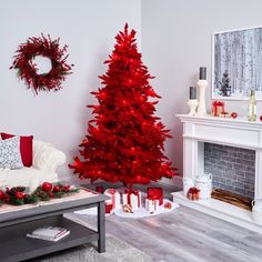 a living room decorated for christmas with red and white decorations on the fireplace mantel